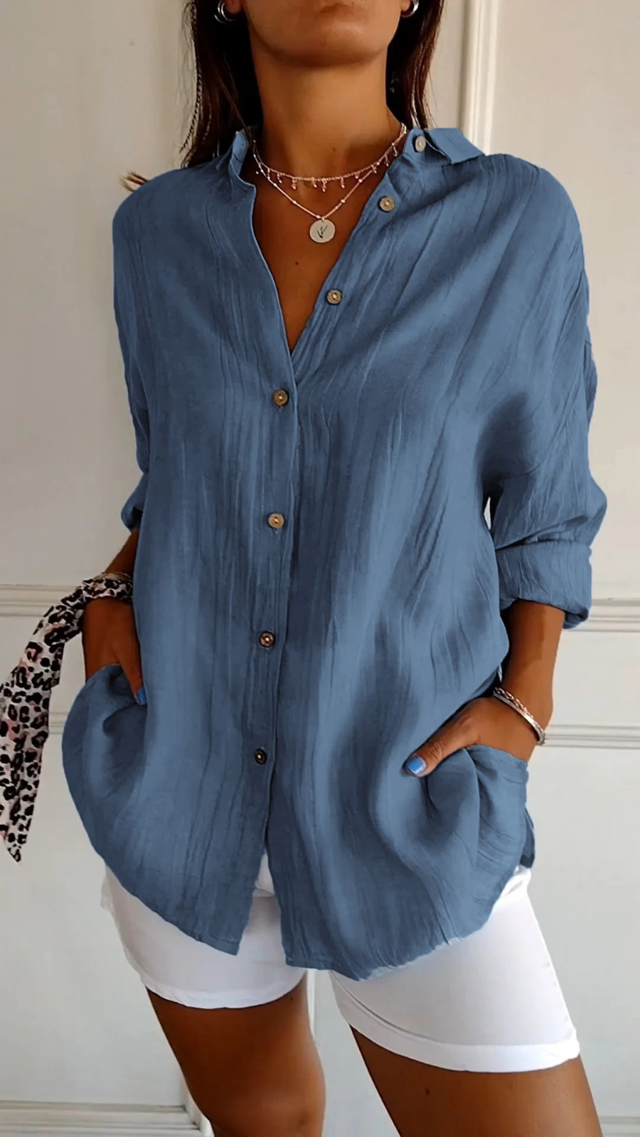 Women's oversized button-down shirt with pointed collar and rolled sleeves