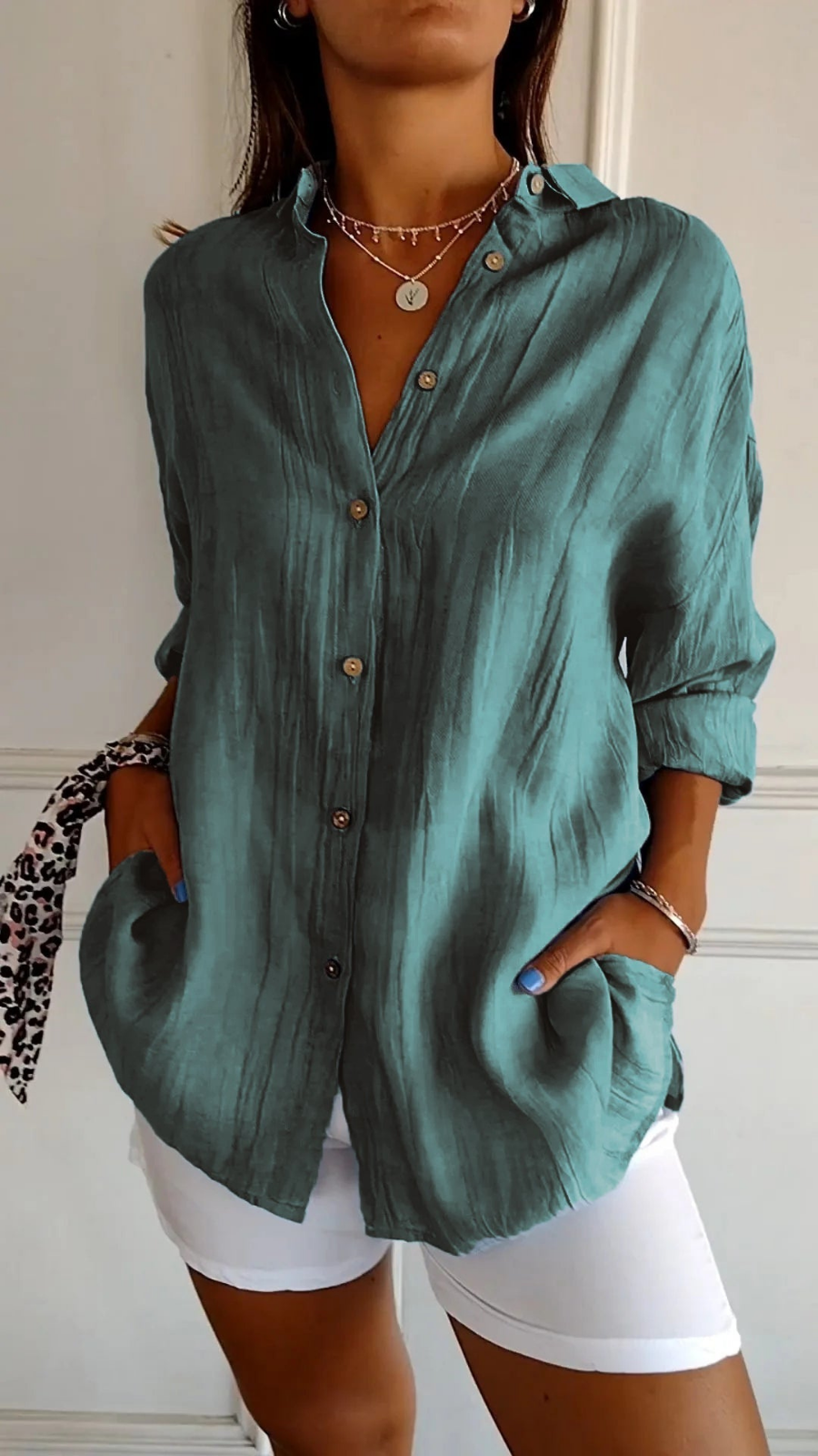 Women's oversized button-down shirt with pointed collar and rolled sleeves
