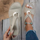 Women's open-toe sandals with crossed straps and circular centre detail