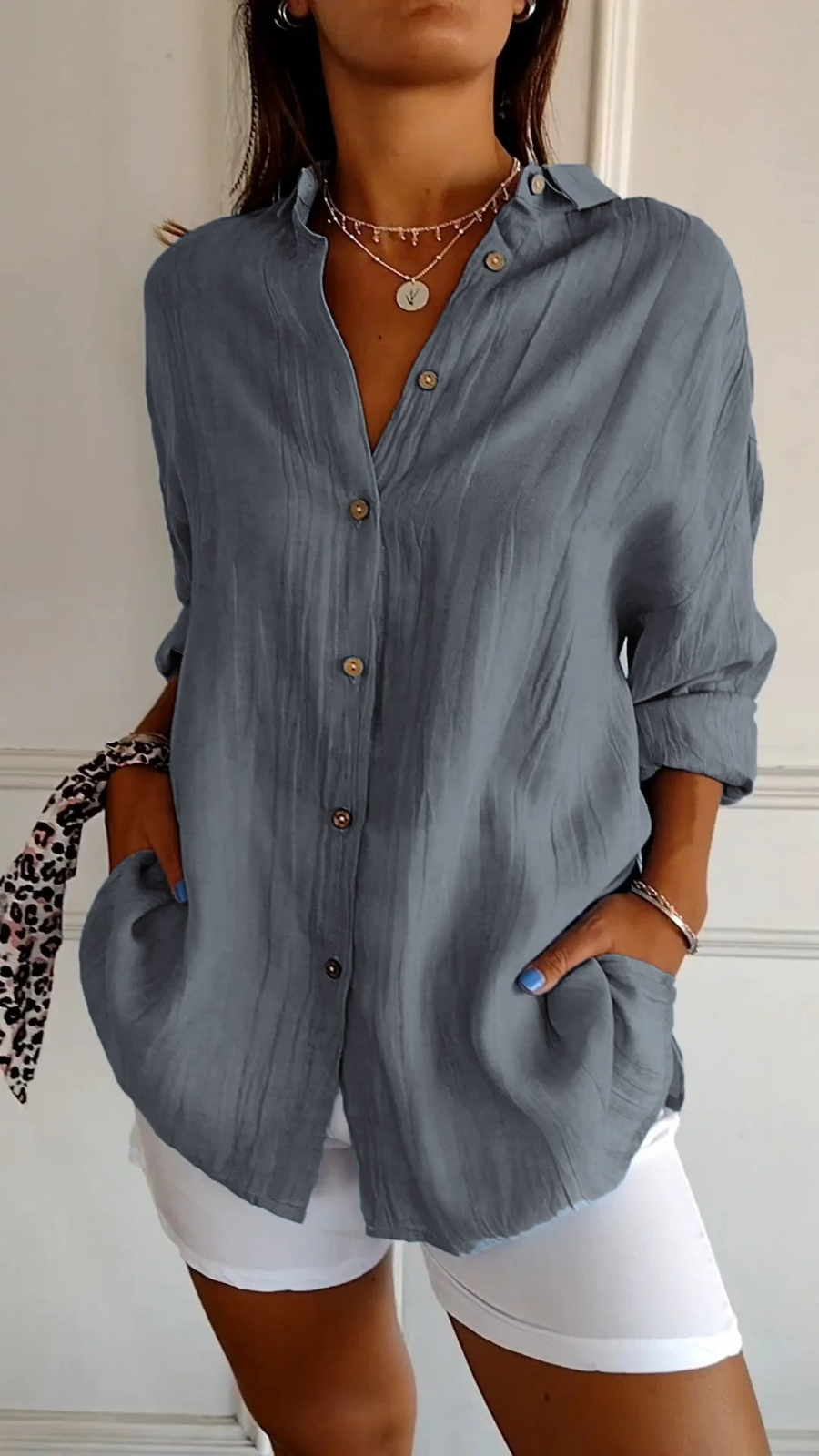Women's oversized button-down shirt with pointed collar and rolled sleeves