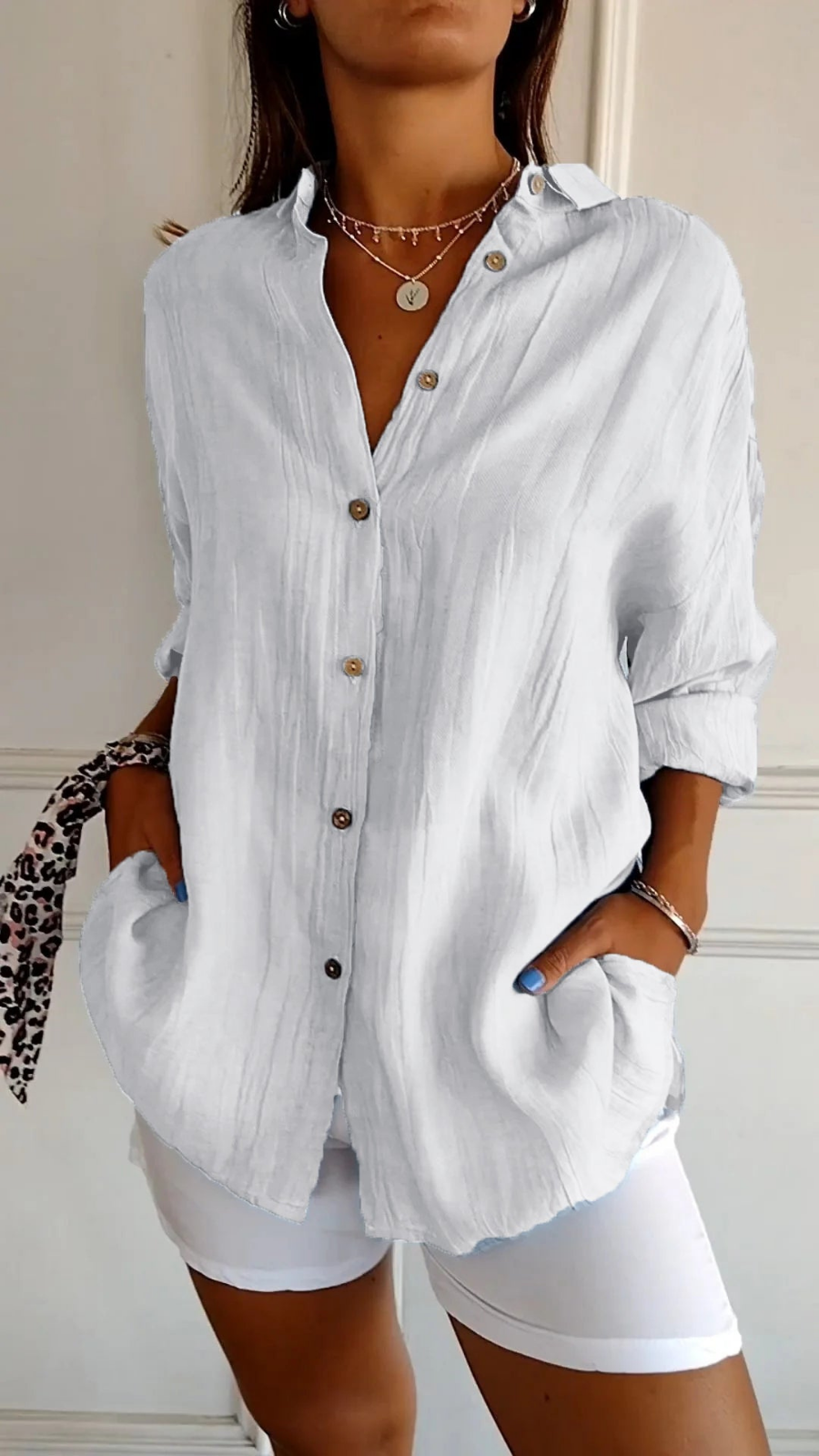 Women's oversized button-down shirt with pointed collar and rolled sleeves