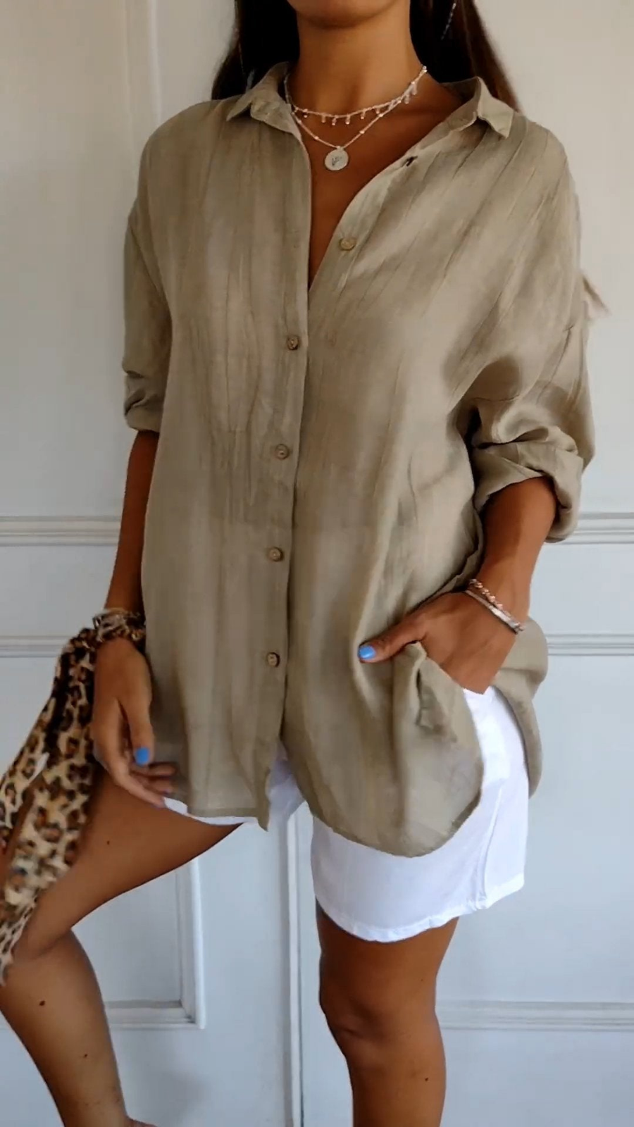Women's oversized button-down shirt with pointed collar and rolled sleeves