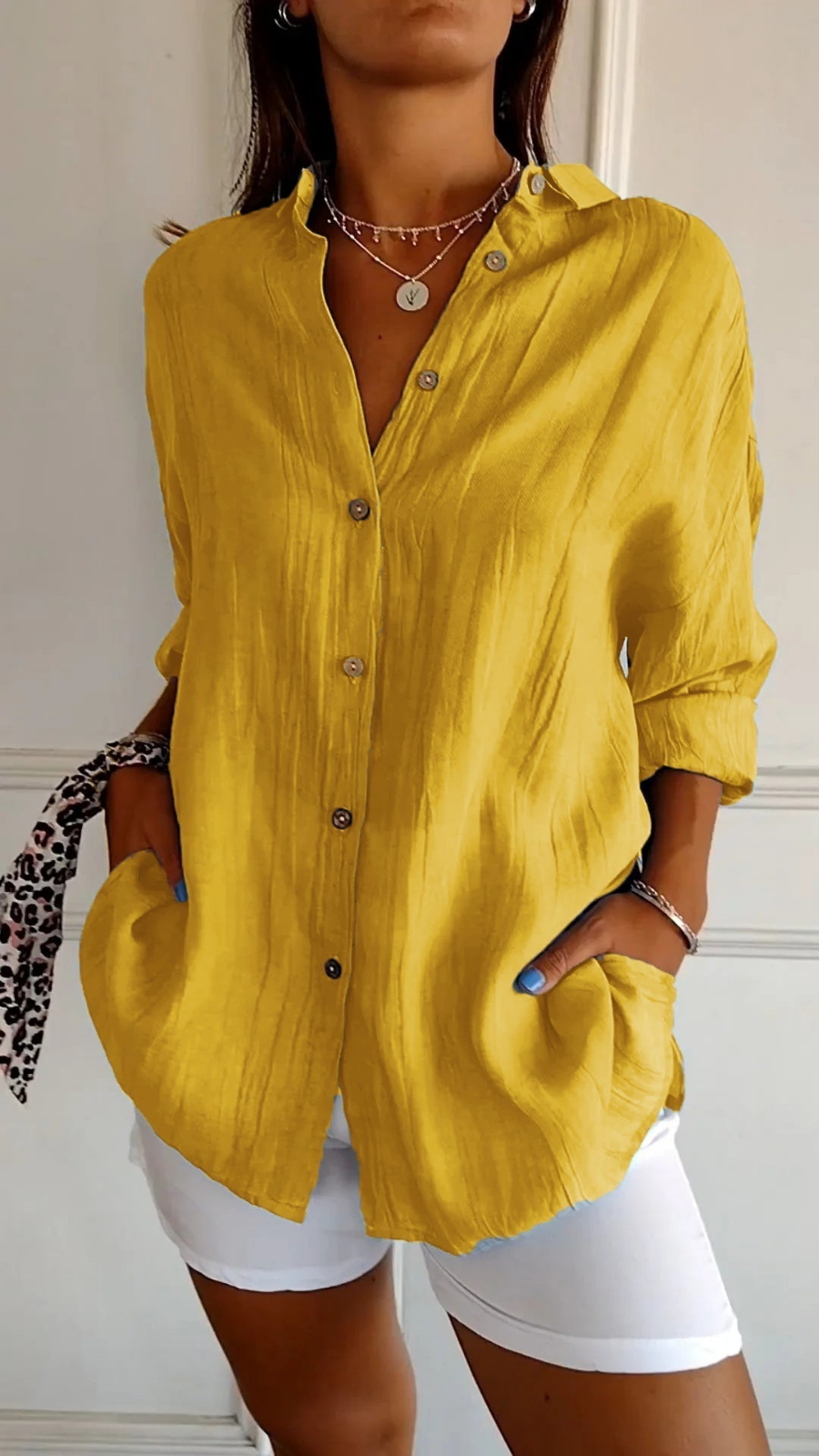 Women's oversized button-down shirt with pointed collar and rolled sleeves